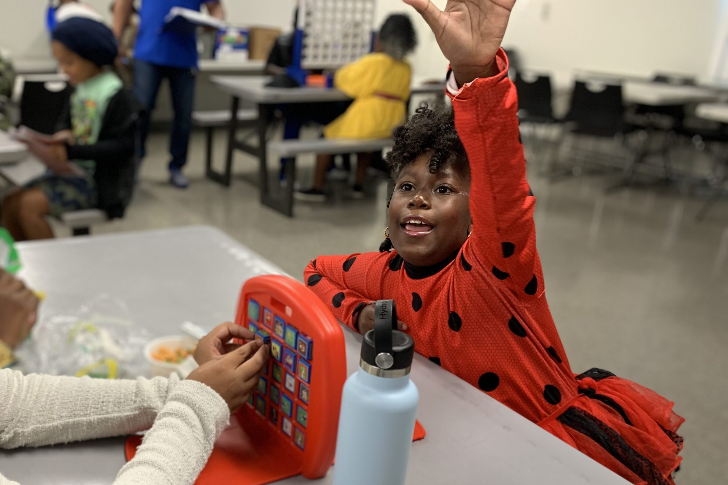 Little girl raising her hand